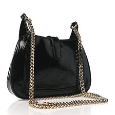 This is an authentic GUCCI Crinkled Patent Mini Jackie Notte Bag in Black. This stylish hobo is crafted of luxuriously crinkled patent leather in black. The bag features a polished gold chain link shoulder strap with a polished gold piston closure. This opens to a red leather interior with pockets. Leather Interior, Chain Link, Red Leather, Gold Chain, Gold Chains, Patent Leather, Shoulder Strap, Gucci, Chain