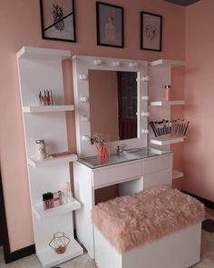 a white vanity with lights on it and a pink wall