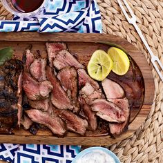 sliced meat and vegetables on a wooden platter