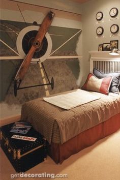 a bed room with a neatly made bed and clocks on the wall