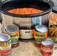 the crock pot is full of beans and other things to make it into soup