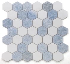 blue and white hexagon tiles are arranged in an irregular pattern on the wall