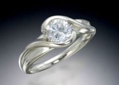 a white gold ring with a diamond in the center