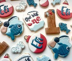 decorated cookies are arranged in the shape of letters and fish, including one for each letter