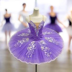 there is a mannequin wearing a purple dress in the middle of a dance class