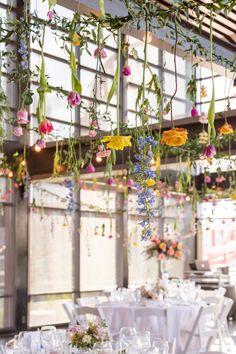 Colorful Garden-inspired Wedding Reception Design Flowers Hung From Ceiling, Hanging Flowers At Wedding, Garden Wedding Ideas Indoor, Hanging Flowers Pergola, Hanging Flower Wedding Arch, Wedding Flowers From Ceiling, Indoor Wedding Flowers, Hanging Flower Arch, Hanging Plants Wedding Decor