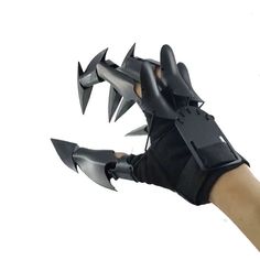 a hand with black gloves and claws on it holding an object in the air,