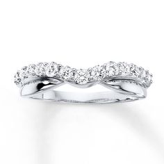 a white gold wedding ring with three rows of diamonds