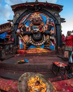 an elaborately decorated statue in the middle of a stage with people standing around it