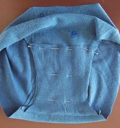 a blue jacket with pins sticking out of it