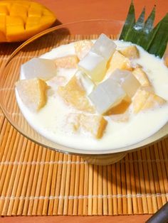 a bowl filled with ice cream and cubes of butter on top of a bamboo mat