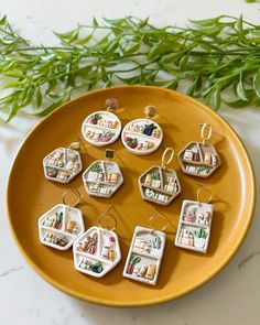 small ceramic ornaments are arranged on a yellow plate