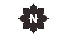 the letter n is made up of black leaves and has a white outline on it