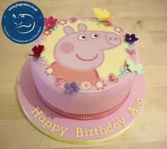 a peppa pig birthday cake on a table