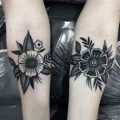 two black and white flower tattoos on both legs