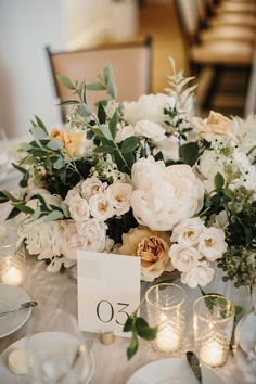 the table is set with flowers and candles for an elegant wedding reception or special event