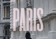 a woman is walking down the street in paris