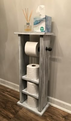 an old wooden cabinet with toilet paper on it