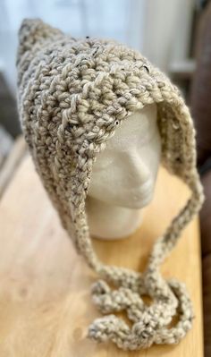 a crocheted hat is on top of a mannequin's head