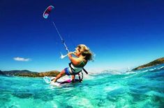 a woman is kite surfing in the ocean