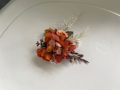 an arrangement of flowers on a white plate