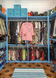 a blue closet filled with lots of clothes