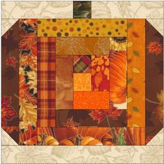 a patchwork quilt with autumn leaves and pumpkins