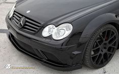 the front end of a black mercedes cla