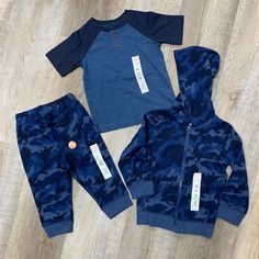 Navy Camo Set. Includes: Full Zip Hoodie Jacket (24 Months) , Short Sleeve Shirt (18 Months) And Pants (18 Months). Playful Blue Sets For Fall, Playful Blue Outerwear For Playtime, Blue Hooded Top For Playtime, Blue Cotton Outerwear For Playtime, Blue Winter Playwear Sets, Blue Playtime Sets For Fall, Casual Navy Playwear Sets, Navy Casual Playwear Sets, Navy Camo