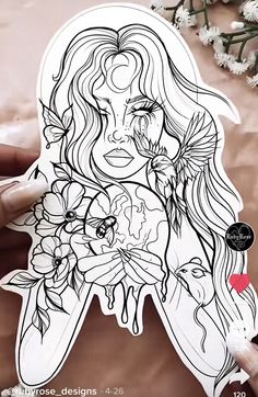 a woman with long hair and flowers on her face is holding up a sticker