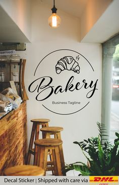 the bakery logo is displayed in front of a white wall with black lettering and wooden stools