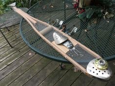 a table that has some kind of fishing rod on top of it with other items