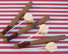 baseball themed cake pops on a red and white striped tablecloth with the word dad written on them