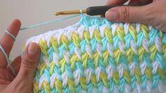 someone is crocheting the stitchs on a piece of yarn