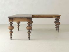 an old wooden table with two legs