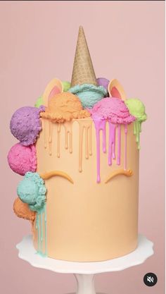 a cake with ice cream and rainbow icing