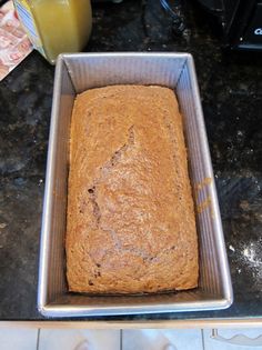 a loaf of bread sitting on top of a metal pan