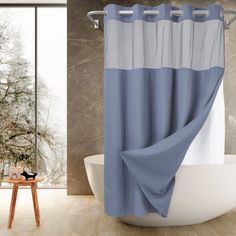 a bathroom with a bathtub, shower curtain and wooden stool in front of it