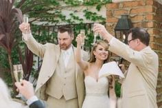 the bride and groom are taking pictures with their cell phones as they walk down the aisle