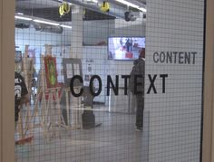 a man standing in front of a glass window with the words content next to it