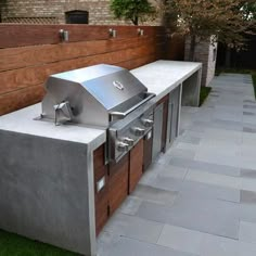 an outdoor bbq grill in the middle of a yard