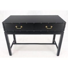 a black desk with two drawers and gold handles on the top, against a white background