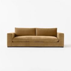 a brown couch sitting on top of a white floor