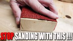 a person is sanding with red sand on top of a piece of wood and the words stop sanding with this