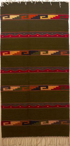 a multicolored area rug with fringes on it