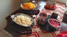 a table topped with bowls filled with different types of food and snacks on top of it