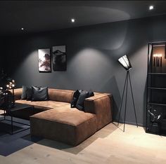 a living room filled with furniture and decor on top of a hard wood floored floor