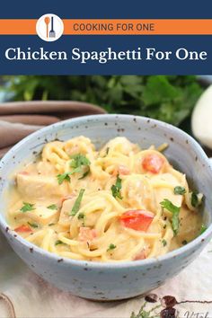 chicken spaghetti for one in a blue bowl with parsley on the side and text overlay