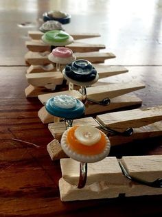 a row of wooden pegs with different colored buttons on them