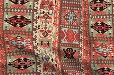 an old rug with many different colors and patterns on the side, as well as numbers